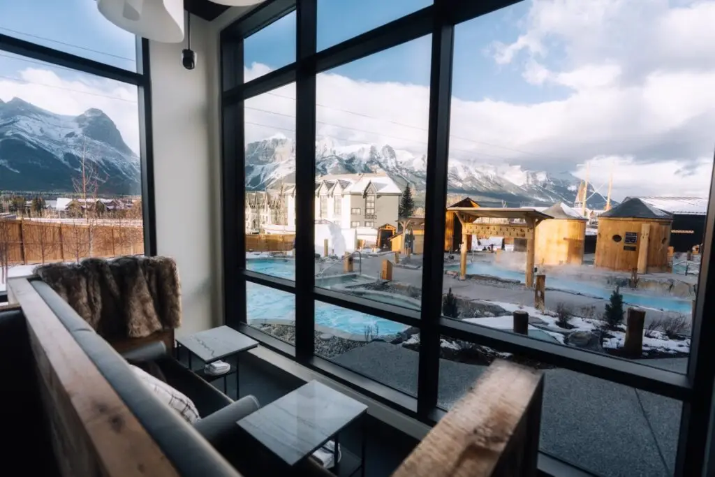The Elements Lounge: View of outdoor hot springs and snowy mountains.