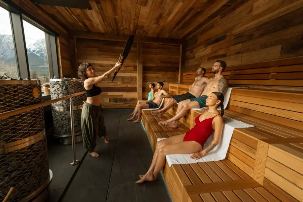 People resting in a wooden sauna during a resting stone ritual.