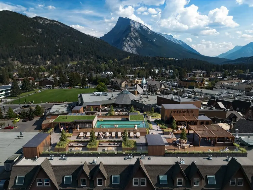 Everwild rooftop pool and lounge area in Banff, Alberta, with mountains.