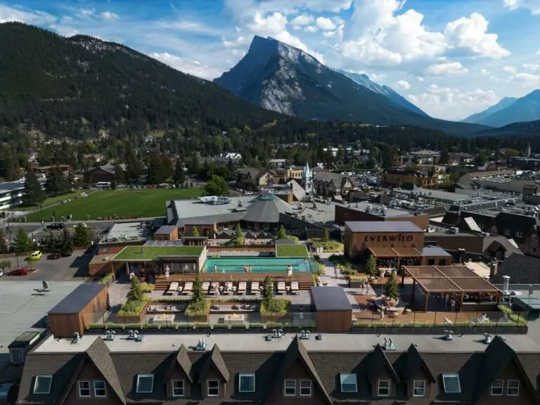 Everwild rooftop pool and lounge area in Banff, Alberta, with mountains.