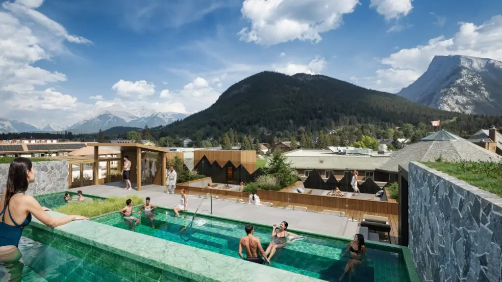 Rooftop pool with mountain views, people relaxing in hot tubs and pool