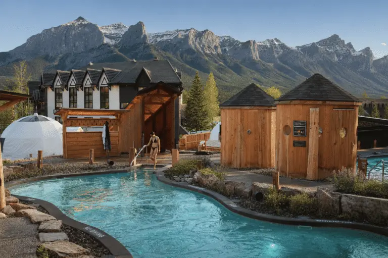Luxury spa with mountain views, outdoor pool, and wooden saunas.